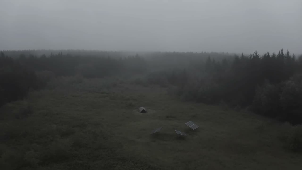 An overcast sky over a bush camp, the light flat and grey